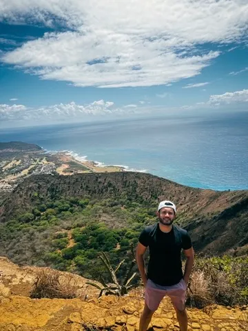 Prateek at the Koko Head summit, with Oahu and the ocean behind him.